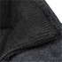 A close-up of a black wool jacket featuring a textured collar and zip detail. The fabric appears warm and stylish.