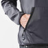 A close-up of a men's polar fleece jacket in grey, featuring a front pocket and a logo.