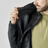 A black Men's Nautilus 3 in 1 Jacket is being held open, revealing its inner lining and design details.