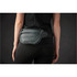 A quilted grey waist bag with a black adjustable strap worn at the waist. The bag features a zipper and a logo.