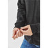 A close-up of a person adjusting the cuff of a dark grey fleece hoodie with a zip.