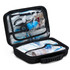 A black first aid kit opened to reveal various medical supplies, including scissors and blue containers.
