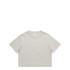 A light beige cropped T-shirt featuring a round neckline and short sleeves, with a logo tag on the inside.