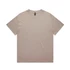 A heavy faded tee in a light beige colour, featuring a simple design and a tag at the neckline.