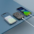 A black 5000 mAh MagSafe power bank displayed alongside two smartphones, showcasing wireless charging features.