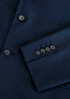 A navy blue jacket featuring a sleek design and buttoned cuffs, with a subtle logo present.