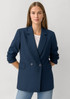 A women's navy double-breasted longline jacket with long sleeves and side pockets.