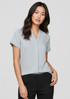 A light blue women's short sleeve button-up shirt displayed on a model, featuring a v-neckline and rolled sleeves.