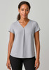 A grey women's blouse featuring a V-neck and pleat design, paired with black trousers, presented on a model.