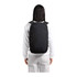 A black Bellroy Via Backpack 20L is worn on the back of a person in casual attire, showcasing its sleek design.