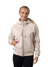 A women's cotton zippered hoodie in beige with a kangaroo pocket and a logo. Model is smiling and wearing black leggings.