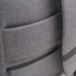A grey backpack featuring multiple pockets and a sleek design, with a logo on the surface.