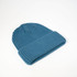 A teal Fisherman's Beanie with a ribbed texture and folded cuff, displayed on a light background.