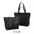 A black tote bag with dual shoulder straps, featuring a zippered closure and a simple design. It has a logo on the side.