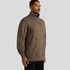 A man wearing a brown Stencil Half Zip Crew jumper, featuring a high collar and a front zip. The product has a logo.