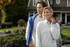 A grey crew neck sweatshirt is worn by a smiling woman outdoors, alongside a man in a blue sweatshirt. A grey crew neck sweatshirt is worn by a smiling woman outdoors, alongside a man in a blue sweatshirt.