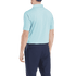 A men's short-sleeve polo shirt in light blue, featuring a subtle strip and a collar, with a dark background.
