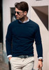 A navy sweatshirt worn by a man, accessorised with sunglasses, walking in a casual outdoor setting.