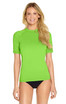 A short sleeve rashie in bright green, featuring a fitted design and a logo on one side.