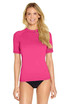 A pink short sleeve rashie with a fitted design, featuring a logo on one side. Suitable for sun protection.