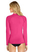 A bright pink long sleeve rashie featuring a high collar and a snug fit, with a logo on the back.