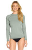 A light green long sleeve rashie with a fitted design, featuring a logo on the front.
