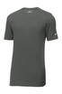 A grey Nike Dri-FIT cotton/poly T-shirt with short sleeves and a logo on one sleeve. A grey Nike Dri-FIT cotton/poly T-shirt with short sleeves and a logo on one sleeve.