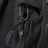 A close-up of a black backpack zipper, featuring a metal pull tab and textured fabric. It has a logo visible. A close-up of a black backpack zipper, featuring a metal pull tab and textured fabric. It has a logo visible.