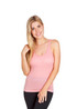 A women's singlet in a soft pink colour, featuring a scoop neckline and shoulder straps. The model has long hair and smiles. A women's singlet in a soft pink colour, featuring a scoop neckline and shoulder straps. The model has long hair and smiles.