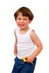 A child in a white singlet and blue jeans, smiling with hands in pockets, showcasing a playful expression.
