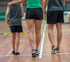 Kids' FLEX shorts in black, showcased on a child and two adults, with a basketball in a gym setting.