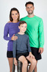 A purple long sleeve T-shirt on a woman, a green one on a man, and a grey one on a boy, all smiling.