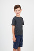 A child wearing a grey heather t-shirt and navy shorts, smiling and standing against a plain background. A child wearing a grey heather t-shirt and navy shorts, smiling and standing against a plain background.