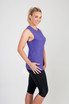 A sleeveless women's tee in heather purple, paired with black leggings, displayed on a model. The shirt features a logo. A sleeveless women's tee in heather purple, paired with black leggings, displayed on a model. The shirt features a logo.