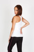 A white kids' T-back singlet is displayed on a model, paired with black pants and featuring a simple design.