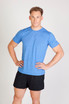 A blue heather T-shirt displayed on a model, paired with black shorts. The shirt has a logo on it.