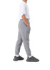 A pair of grey three-layer cotton track pants with side pockets, modelled by a person wearing a white t-shirt and sneakers.