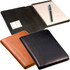 A junior portfolio featuring three designs in black, brown, and green sueded full-grain leather, including a notepad and pen.