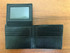 A black men's wallet with multiple card slots and a transparent ID window. The wallet is made of textured leather. A black men's wallet with multiple card slots and a transparent ID window. The wallet is made of textured leather.