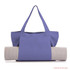 A lavender yoga mat canvas bag featuring sturdy handles, holding a rolled yoga mat. Includes a logo on the bag.