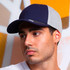 A navy and grey cap with a logo, featuring a curved brim and a structured design.