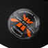 A black cap with a circular logo featuring orange and white elements, made from organic cotton.
