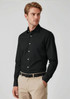 A black long sleeve button-up shirt worn by a model, featuring a sleek design and a collar, paired with beige trousers.
