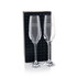 A twin pack of clear champagne flutes in a black box, featuring elegant stemware design and branding.
