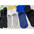 A selection of Crew Grip socks in black, white, blue, and green, featuring rubber grip soles and a logo.