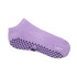 A low cut grip sock in light purple featuring textured grip dots on the underside. It has a brand logo displayed.