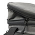 A grey cooler bag with a double zipper and black zip pulls, featuring a sturdy handle for carrying.