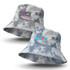 A grey and blue tie dye bucket hat featuring a logo on one side and text on the other.