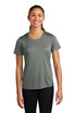 A smiling woman wearing a green Sport-Tek Ladies PosiCharge Competitor Tee and black leggings, standing with arms relaxed.