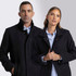 A black wool jacket featuring a collar, worn by a man and a woman, both in smart casual attire.